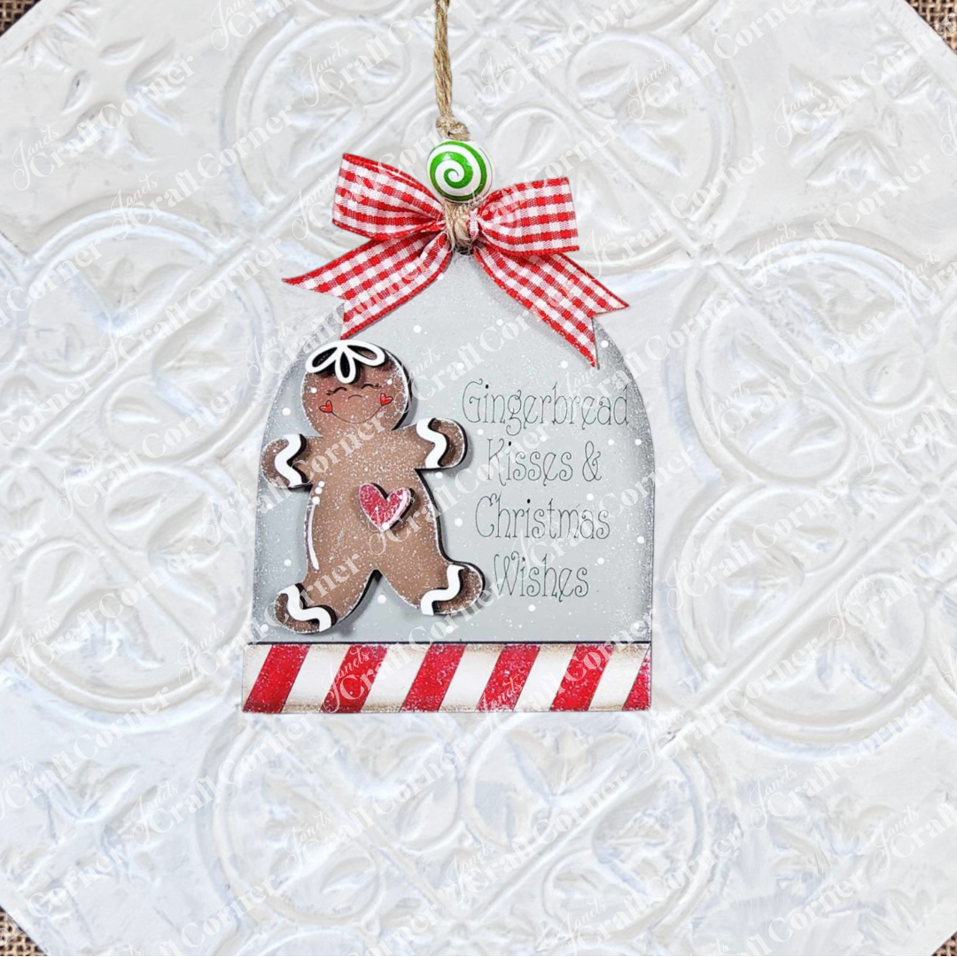 Add festive charm with Janet's Craft Corner Gingerbread Ornaments DIY kit. This set of 8 features gingerbread men, red-and-white bases, heart accents, bows, green swirls, and a "Gingerbread Kisses & Christmas Wishes" motif.