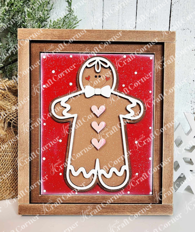 Gingerbread Man Switchable Farmhouse Sign and Farmhouse Frame painted sample by Janet's Craft Corner. Sign features a cinnamon-colored gingerbread man with white icing trim on a red background.