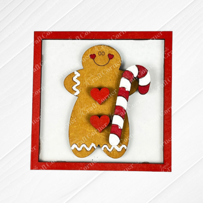 Gingerbread Squares by Janet's Craft Corner: A gingerbread cookie with white icing, red hearts, and a candy cane on a white background with a red border. Ideal for swappable square displays or tiered tray signs in your seasonal DIY home decor.