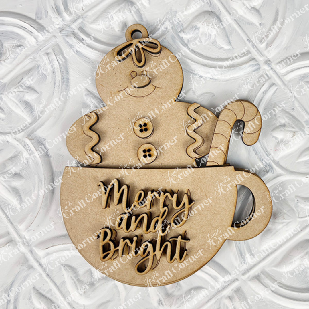 The Gingerbread Ornaments DIY holiday craft kit by Janet's Craft Corner includes 8 wooden ornaments featuring smiling gingerbread figures in cups with candy canes, "Merry and Bright" text, and a textured white background—perfect for festive décor.