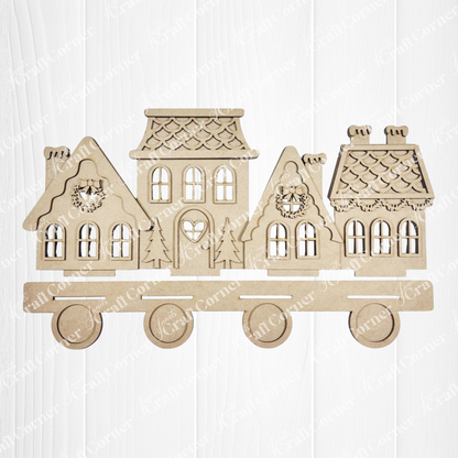 The Gingerbread Village Votive Holder Shelf Sitter by Janet's Craft Corner features four festive, connected houses on wheels—ideal as seasonal home decor. Display this charming accent on a white wooden surface for a cozy holiday touch.