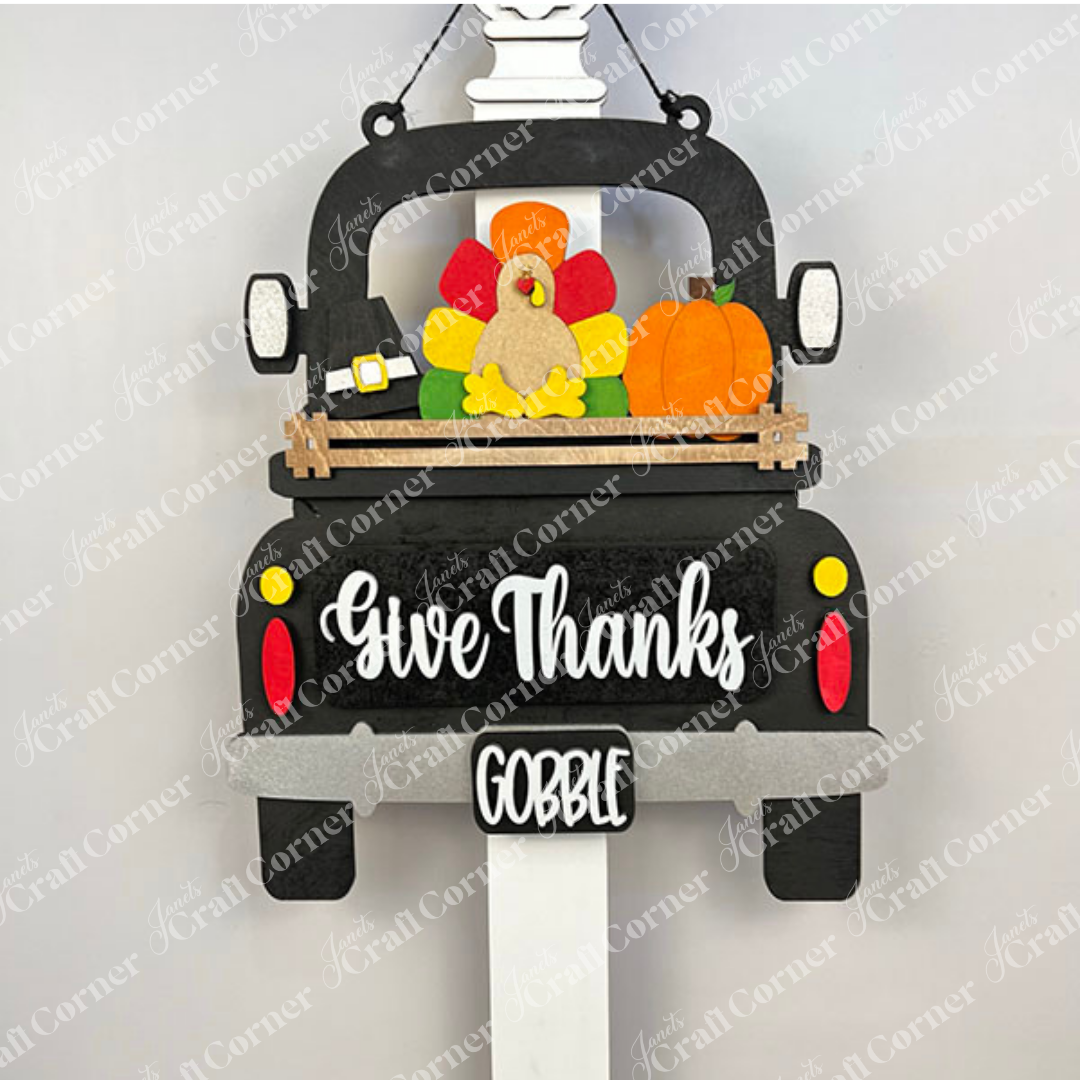 The Give Thanks Interchangeable Insert from Janet's Craft Corner is a DIY home decor kit featuring a truck-shaped sign with a turkey theme. Includes felt turkey, pilgrim hat, and pumpkin. Tailgate says "Give Thanks," license plate reads "GOBBLE." Perfect for festive holiday decorating.