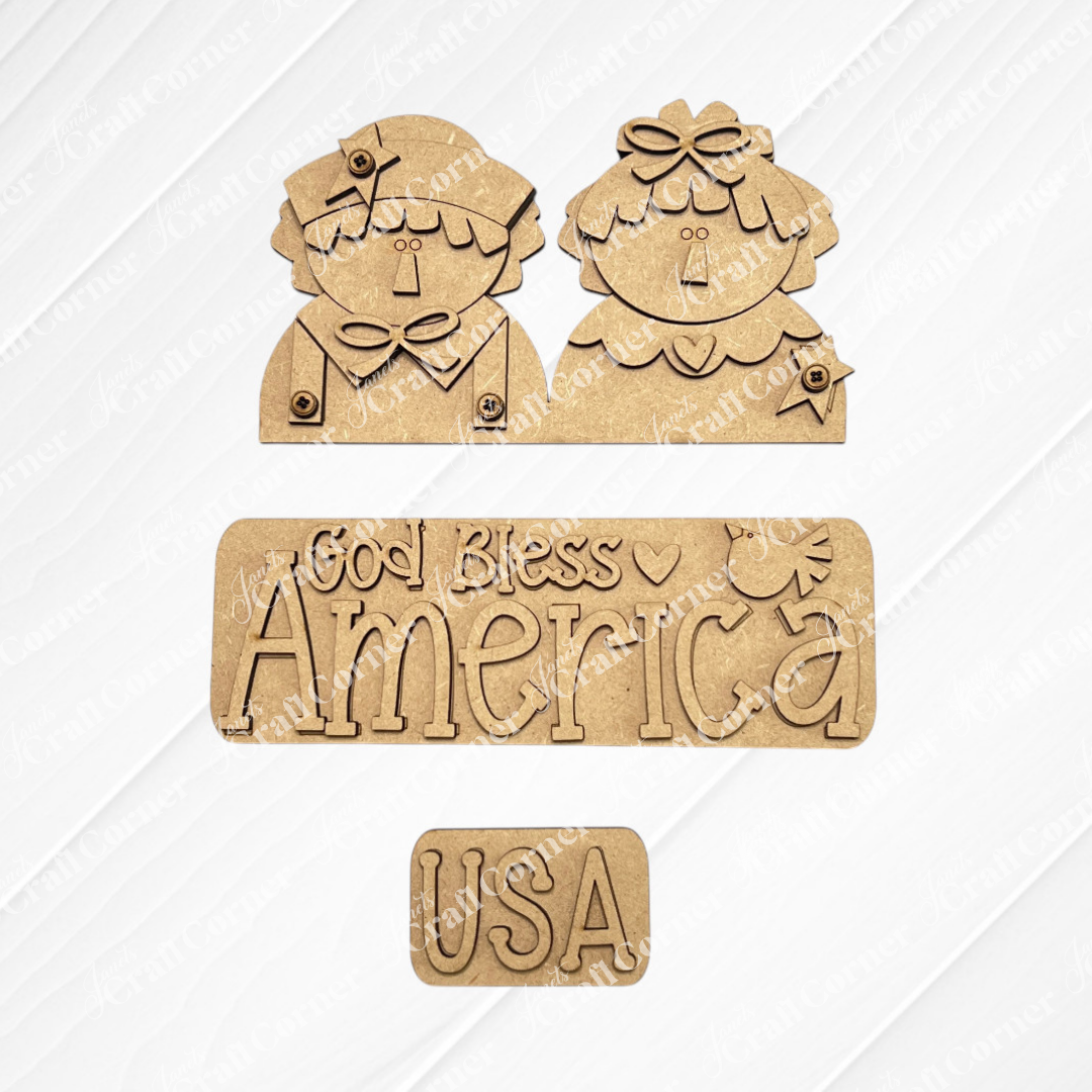 Janet's Craft Corner offers the God Bless America Interchangeable Insert DIY craft kit—1 set of 3 laser-cut wood pieces including cartoon-style figures, a "God Bless America" heart/star sign, and a "USA" plaque for seasonal home decor.
