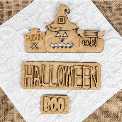 Janet's Craft Corner presents the Halloween Pumpkin Interchangeable Insert—an ideal DIY home decor kit. It features wooden Halloween decorations on a textured white background: a pumpkin adorned with a witch hat labeled "poison" and "eek!", alongside a sign that reads "HALLOWEEN," and a small plaque with the word "BOO!" All elements rest atop burlap fabric, offering perfect pieces for interchangeable craft inserts.