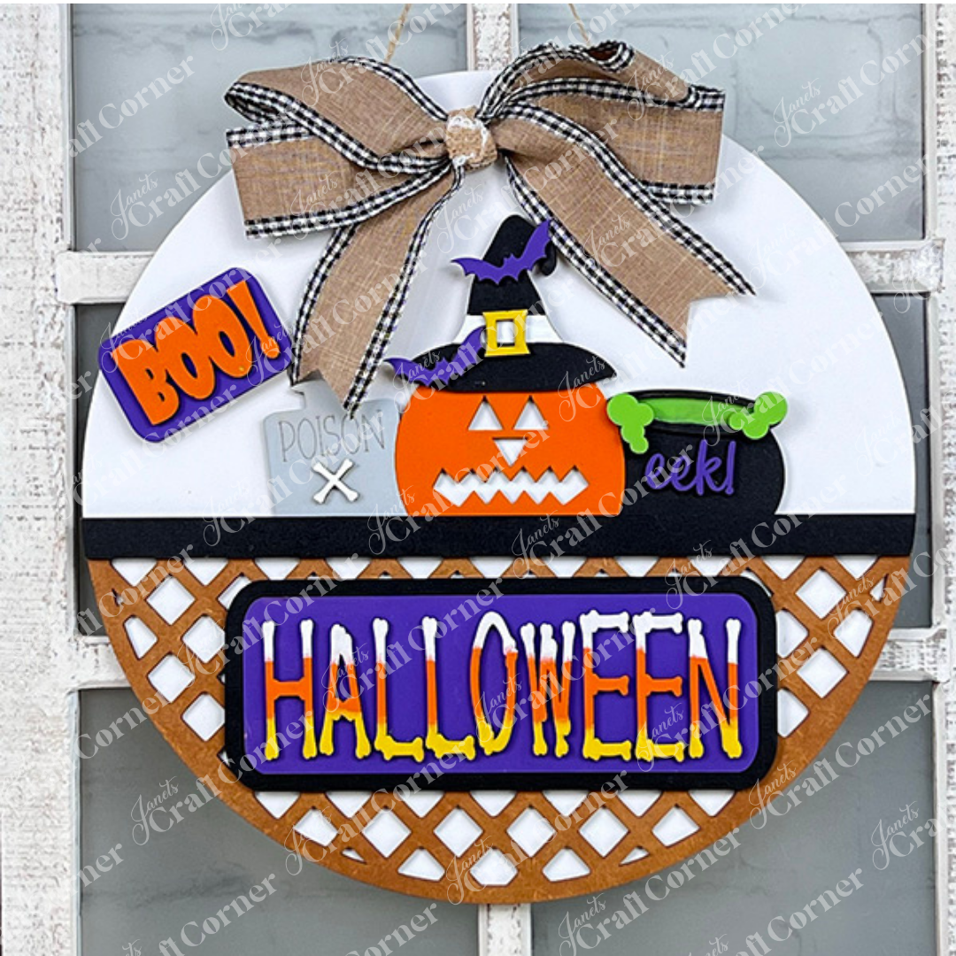 Introducing the Halloween Pumpkin Interchangeable Insert from Janet's Craft Corner, a perfect addition to your DIY home decor kit. This round door sign showcases a charming pumpkin wearing a witch hat, a cauldron that exclaims "eek!", and the bold word "BOO!" A delightful bow adorns the top, while "HALLOWEEN" elegantly spans across the lattice bottom, making it ideal for festive interchangeable craft inserts.