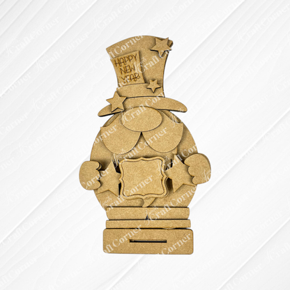 The Happy New Year Gnome Shelf Sitter by Janet's Craft Corner features a top-hatted gnome holding a star with "Happy New Year" text and chest space for customization, donned with star decorations, making it perfect for DIY personalization as part of this delightful seasonal home decor craft kit.