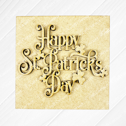 The St Patricks Squares sign from Janet's Craft Corner features elegant script "Happy St. Patrick's Day" with shamrock shapes, perfect for tiered tray decor on a light wood background.