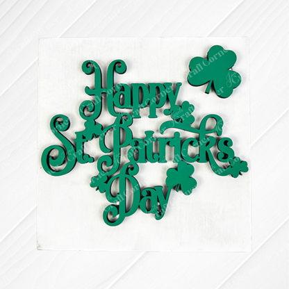 Janet's Craft Corner’s St Patricks Squares feature green "Happy St. Patrick's Day" text with clover accents on white—ideal for tiered tray decor or pairing with wood cut-outs for a festive Irish-themed look.