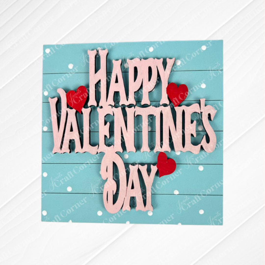 The Valentine Squares by Janet's Craft Corner features a wooden sign with pink "Happy Valentine's Day" letters on a blue background with white polka dots and red hearts—ideal for DIY seasonal home or tiered tray decor.