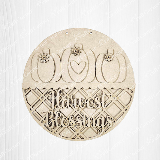 Janet's Craft Corner Harvest Blessings Wall Hanger DIY kit features three pumpkins with floral and heart accents above a lattice, plus “Harvest Blessings” cut out—perfect for creating your own fall home decor. Set of 1.