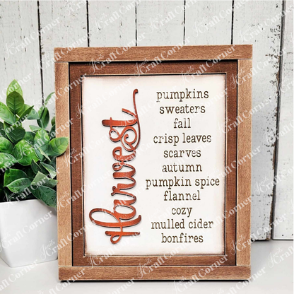 The Farmhouse Frame for Interchangeable Signs by Janet's Craft Corner offers a cozy autumn vibe with fall-themed words like harvest, pumpkins, and crisp leaves. Ideal for decor enthusiasts, this DIY craft kit pairs perfectly with a small potted plant to complete the look.
