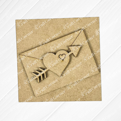 The Love Squares card from Janet's Craft Corner is a square brown piece featuring a heart pierced by an arrow and a smaller cut-out heart inside, set on a textured background—perfect for DIY seasonal home decor.