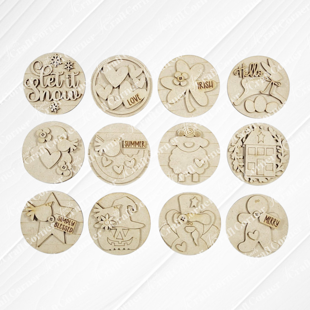 The Saltbox House Round Display by Janet's Craft Corner is a DIY seasonal home decor craft kit that includes one engraved wooden ornament with designs like "let it snow," "hello," and various festive motifs.