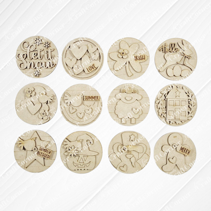 The Saltbox House Round Display by Janet's Craft Corner is a DIY seasonal home decor craft kit that includes one engraved wooden ornament with designs like "let it snow," "hello," and various festive motifs.