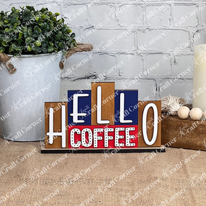 Enhance your home decor with the "Hello Coffee Mini Word Block" from Janet's Craft Corner. Featuring vivid white and red lettering against a striking blue and red background on a burlap-covered surface, this charming piece is perfect for your next DIY kit project set against a white brick wall.