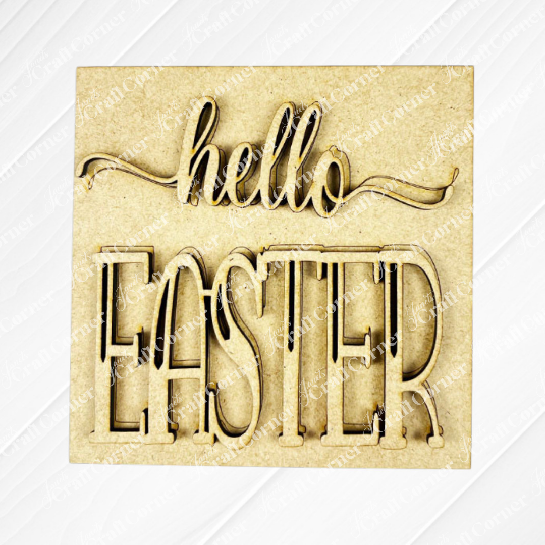 Janet's Craft Corner's "Hello Easter Squares" sign features "hello EASTER" in stylish script and bold font, making it a charming coffee-themed decor piece for any light-toned, textured setting.