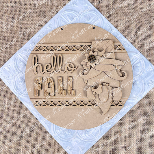 The Hello Fall Gnome Door Hanger from Janet’s Craft Corner features a gnome in a floral hat with a bird on a burlap background. This DIY kit includes everything needed to create this charming fall door hanger, perfect for seasonal home décor.