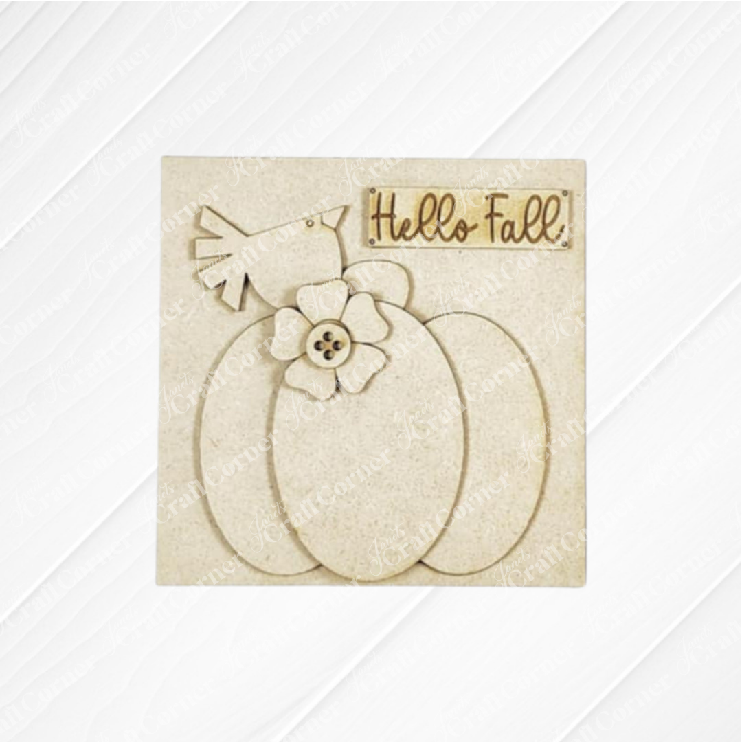 Janet's Craft Corner’s Fall Scarecrow Mini Shelf Sitter DIY kit features a beige, rustic-style scarecrow with a pumpkin accent and "Hello Fall!" tag—perfect seasonal decor or inspiration for your next autumn craft project.