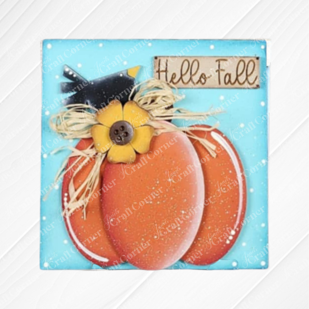 The Hello Fall Squares by Janet's Craft Corner is a rustic fall decoration with wood cut-outs of an orange pumpkin, yellow flower with button center, black bird, raffia bow, blue background, and “Hello Fall” in brown handwritten letters—ideal for tiered trays.