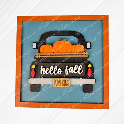 The Hello Fall Squares by Janet's Craft Corner features a decorative wood cut-out sign of a black truck with pumpkins, “hello fall” on the tailgate, and a yellow “PUMPKINS” license plate—ideal for tiered tray décor or Swappable Squares.