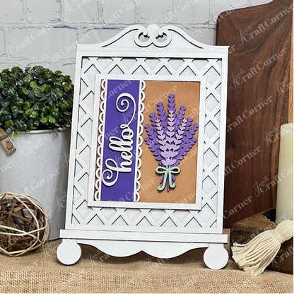 Janet's Craft Corner Cottage Frame for Switchable Farmhouse Signs is a DIY seasonal home decor kit. Display your decorative sign in this white easel-style frame—perfect for adding farmhouse charm to any table alongside plants and candles.