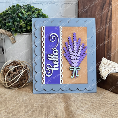 A handmade greeting card inspired by Janet's Craft Corner’s Lavender Switchable Farmhouse Signs DIY Craft Kit, featuring a blue scalloped border, “hello” in white script on purple, and a bouquet of lavender with a blue bow.