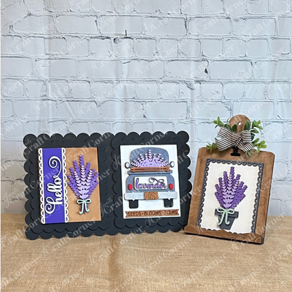 The Lavender Switchable Farmhouse Signs DIY Craft Kit from Janet's Craft Corner features three charming lavender-themed signs—“Hello,” a vintage truck design, and a clipped board with greenery and a striped bow—for your tiered tray décor.