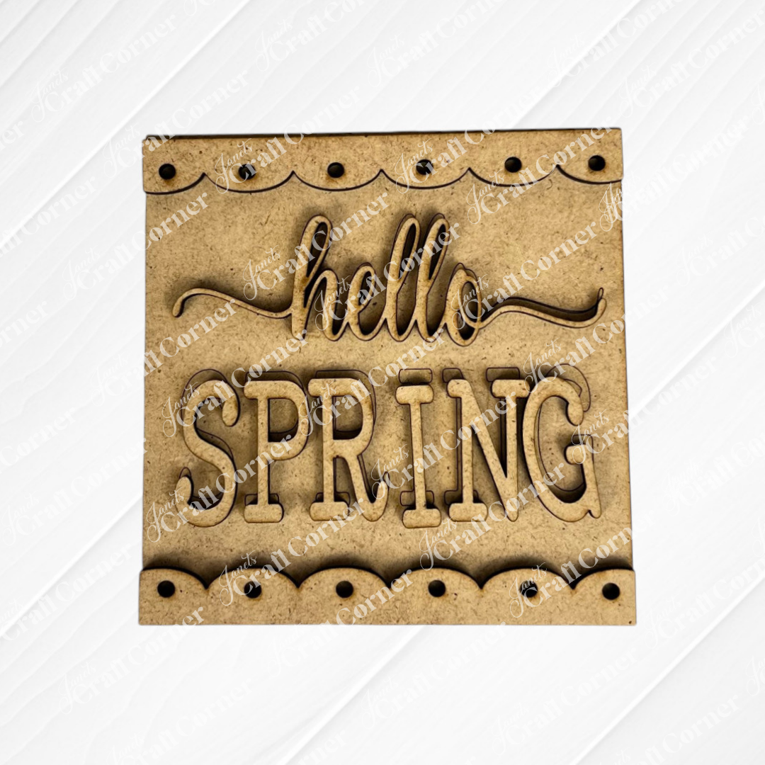 Janet's Craft Corner Hello Spring Squares: a wooden square sign with decorative edging, ideal for tiered tray decor, featuring "hello SPRING" in cursive and block letters.