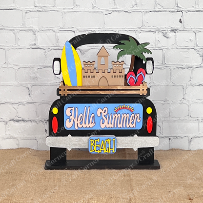 Introducing the Summer Beach Interchangeable Insert, a DIY home decor kit from Janet's Craft Corner. This wooden summer-themed decoration showcases a delightful sandcastle, surfboards, and palm trees. The sign displays "Hello Summer" in colorful letters, making it an ideal piece for adding a vibrant touch to your space.