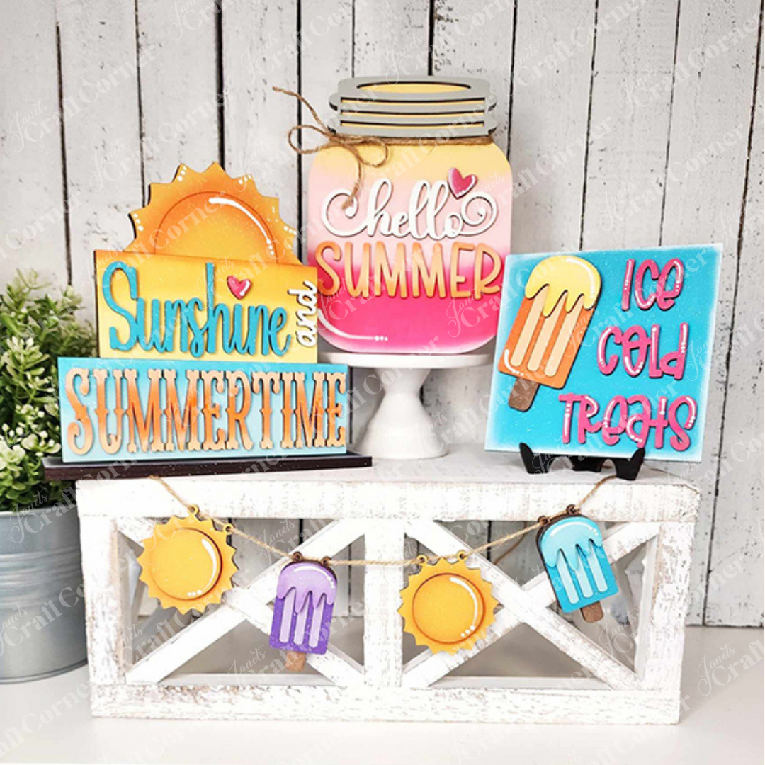 Create a charming summer display with Janet's Craft Corner's Hello Summer Tiered Tray Set, featuring a decorative wooden crate filled with delightful signs and cutouts. The set includes images of a sun, ice cream, and a mason jar labeled "Hello Summer." Enjoy the playful signs that read "Sunshine and Summertime" and "Ice Cold Treats," complemented by small banners of suns and popsicles for the perfect seasonal decor.