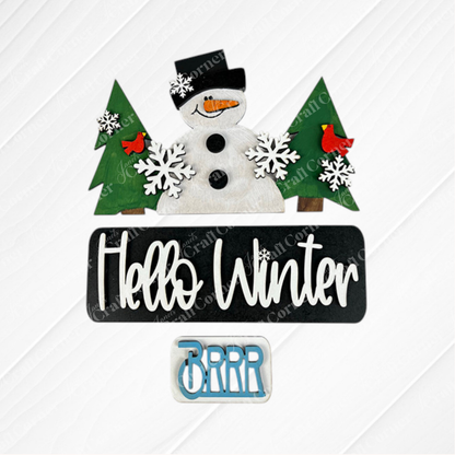 Transform your home this festive season with Janet's Craft Corner's "Hello Winter Interchangeable Insert - Painted." This winter-themed decor showcases a cheerful snowman adorned with a black hat and red scarf, set amidst vibrant green pine trees, charming red cardinals, and delicate white snowflakes. The design features a prominent black sign reading "Hello Winter" alongside a smaller "BRRR" sign, making it an ideal addition for interchangeable inserts on antique truck bases.