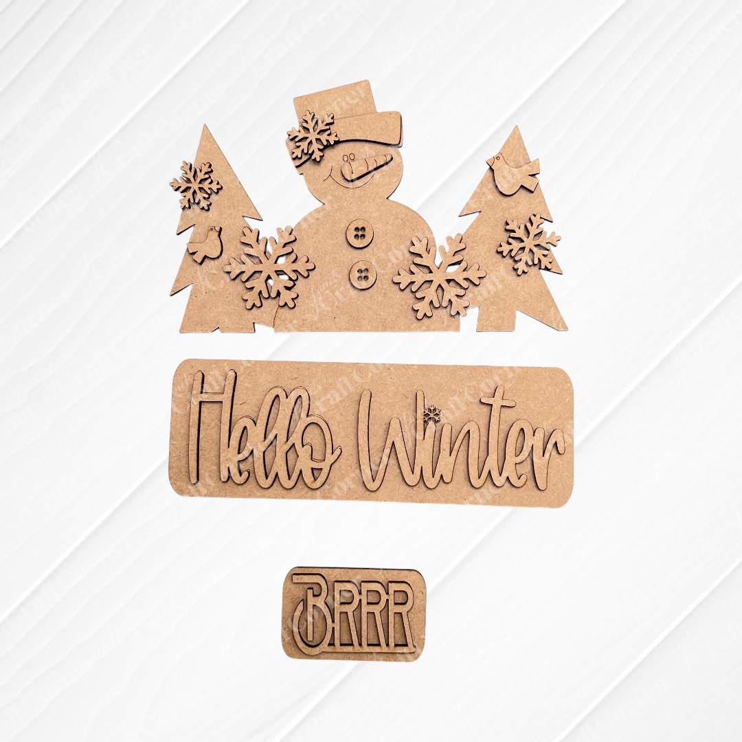 Add a festive touch to your space with Janet's Craft Corner's DIY home decor kit, the "Hello Winter Interchangeable Insert." This kit features wooden cutouts of a snowman in a hat, trees, and snowflakes. It includes pieces that read "Hello Winter" and "Brrr," making it perfect for changing up your home decor on any plain background.