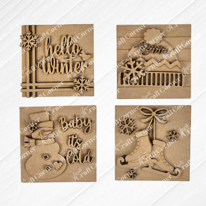 Janet's Craft Corner Hello Winter Squares: four brown, laser-cut wooden ornaments featuring festive designs—"hello winter," "Brrr" mountain, "Baby it’s Cold" snowman, and bells—perfect seasonal decor or tiered tray signs.