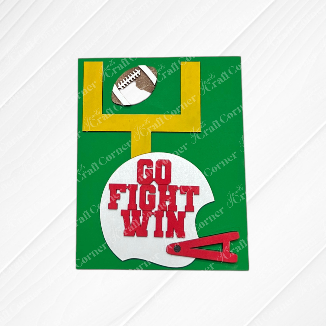 Football Farmhouse Signs by Janet’s Craft Corner feature a football-themed card with a goalpost, football, and a white helmet marked “GO FIGHT WIN” in bold red letters, all set against a lively green background with a crisp white pattern—perfect for inspiring your interchangeable seasonal display or enhancing your next DIY home decor kit.