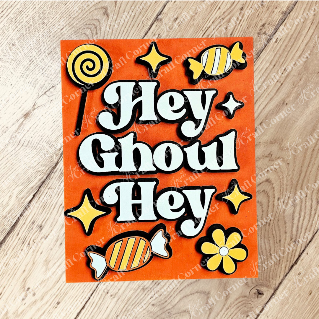 Add festive charm to your home with Janet's Craft Corner Halloween Farmhouse Signs—this orange sign reads "Hey Ghoul Hey" in white and black text, surrounded by yellow accents for perfect DIY seasonal decor.