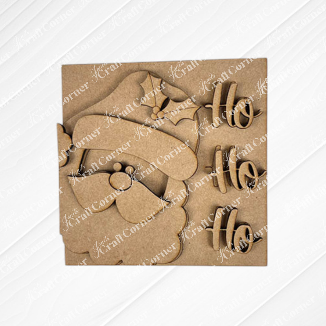 Santa Squares by Janet's Craft Corner: a laser-cut wooden decor with Santa's face and "Ho Ho Ho" on a square backing. This unfinished DIY piece is ideal for customizing and fits perfectly in your Swappable Squares craft kit collection.