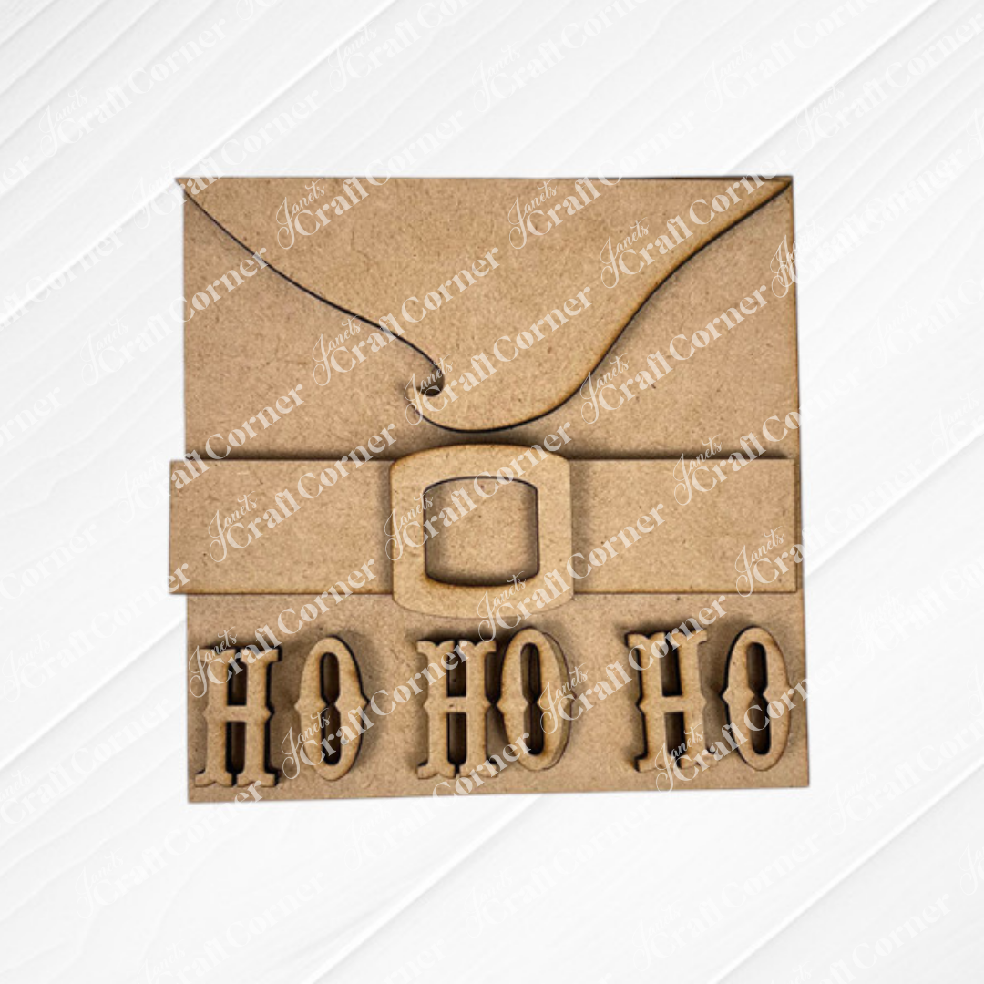 Santa Squares from Janet's Craft Corner is a brown cardboard square card styled like Santa's suit, with a black belt, gold buckle, and “HO HO HO” cut-out letters—ideal for festive DIY home decor. Part of the Swappable Squares craft kit.