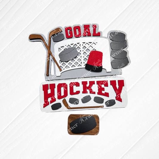 The Hockey Interchangeable Insert - Painted, from Janet's Craft Corner, showcases a decorative hockey-themed design with elements like a goal net, hockey sticks, pucks, and the words "Goal" and "Hockey" in red on a textured white and burlap background. This piece is an ideal addition to your home decor collection.