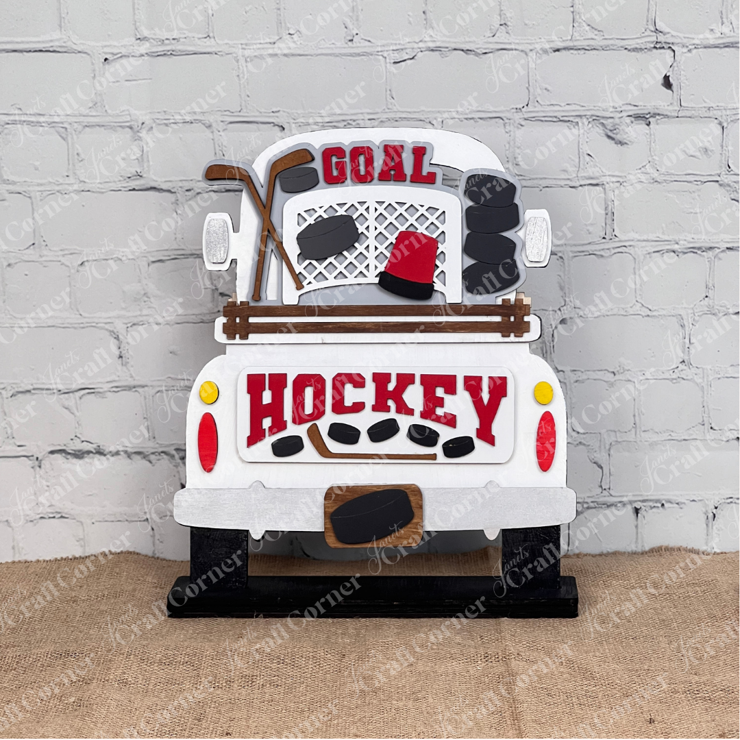 Create a decorative wooden plaque with Janet's Craft Corner's Hockey Interchangeable Insert, a DIY kit featuring hockey-themed elements like sticks, pucks, and a helmet. Display "GOAL" and "HOCKEY" against a white brick wall for the perfect seasonal home decor.