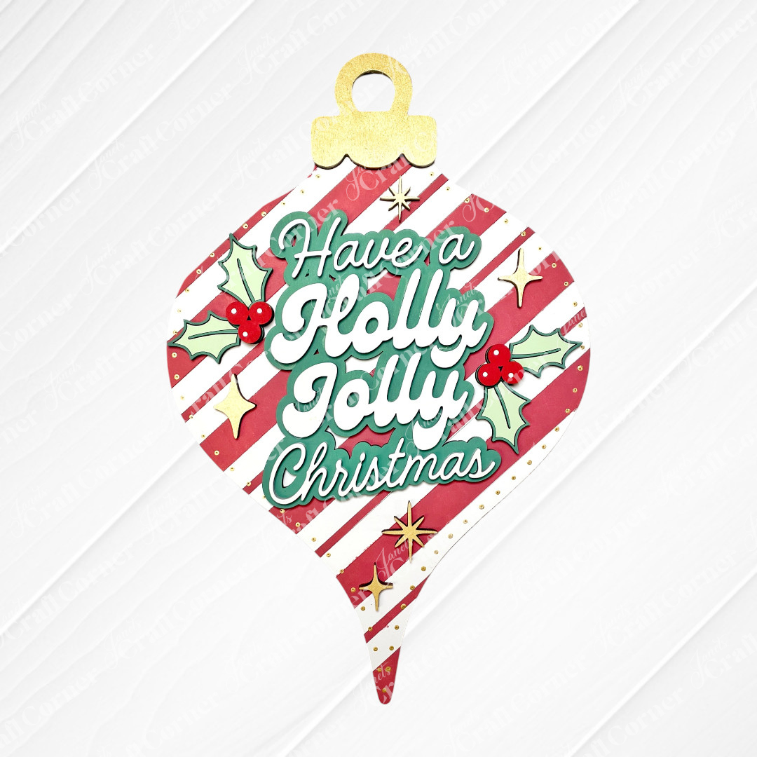 The Holly Jolly Vintage Ornament Door Hanger by Janet's Craft Corner is a DIY home decor kit featuring red and white stripes, gold stars, holly leaves, berries, and “Have a Holly Jolly Christmas” in festive green and white lettering. Set of 1.