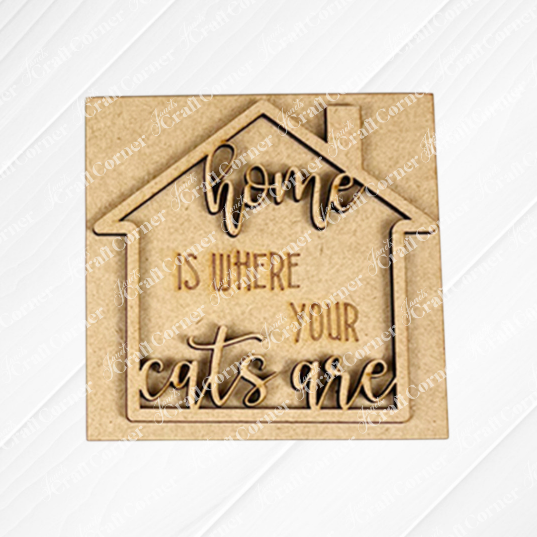 The Cat Swappable Squares by Janet's Craft Corner is a wooden house-shaped sign with "Home is where your cats are" engraved in decorative script, perfect for DIY seasonal home decor in any room.