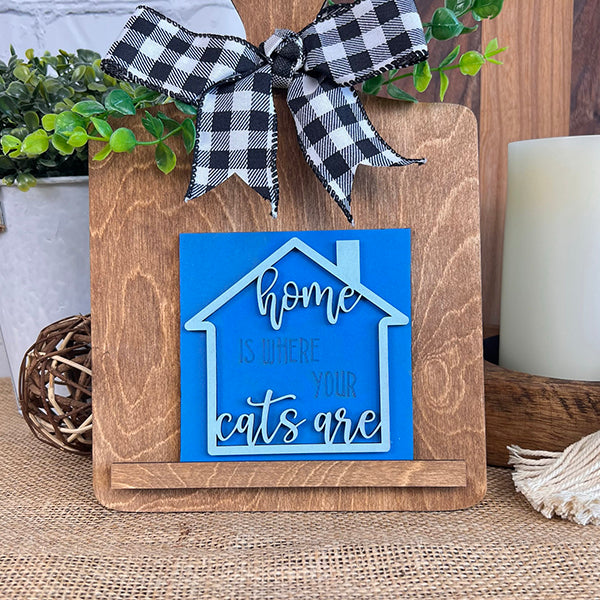 Janet's Craft Corner Cat Swappable Squares feature a wooden display board with a black-and-white checkered bow, green leaves, and a "Home is where your cats are" sign—perfect for charming DIY seasonal tiered tray decor.