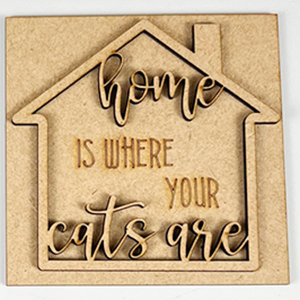 The Cat Swappable Squares by Janet's Craft Corner is a wooden house-shaped sign with "Home is where your cats are" engraved in decorative script, perfect for DIY seasonal home decor in any room.