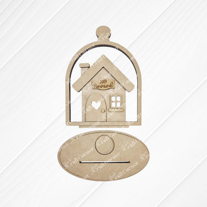The "Home Cloche Votive Holder Shelf Sitter" by Janet's Craft Corner is a wooden cutout of a house engraved with "Welcome," set in a cloche-shaped frame. It features an oval plaque against a lined white background, perfect for DIY craft kit enthusiasts seeking unique home decor.