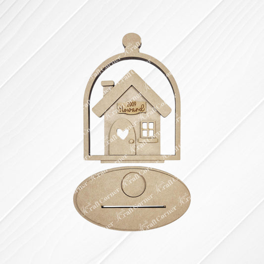 The "Home Cloche Votive Holder Shelf Sitter" by Janet's Craft Corner is a wooden cutout of a house engraved with "Welcome," set in a cloche-shaped frame. It features an oval plaque against a lined white background, perfect for DIY craft kit enthusiasts seeking unique home decor.