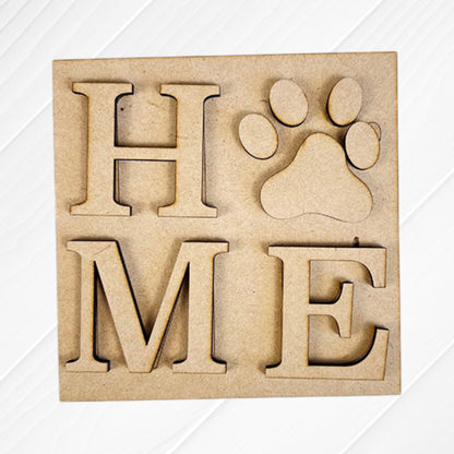 Dog Squares by Janet's Craft Corner: wooden "H", "M", and "E" letters plus a paw print cut-out for the "O" to spell "HOME." Light wood background, ideal for tiered tray decor or customizing with Swappable Squares.