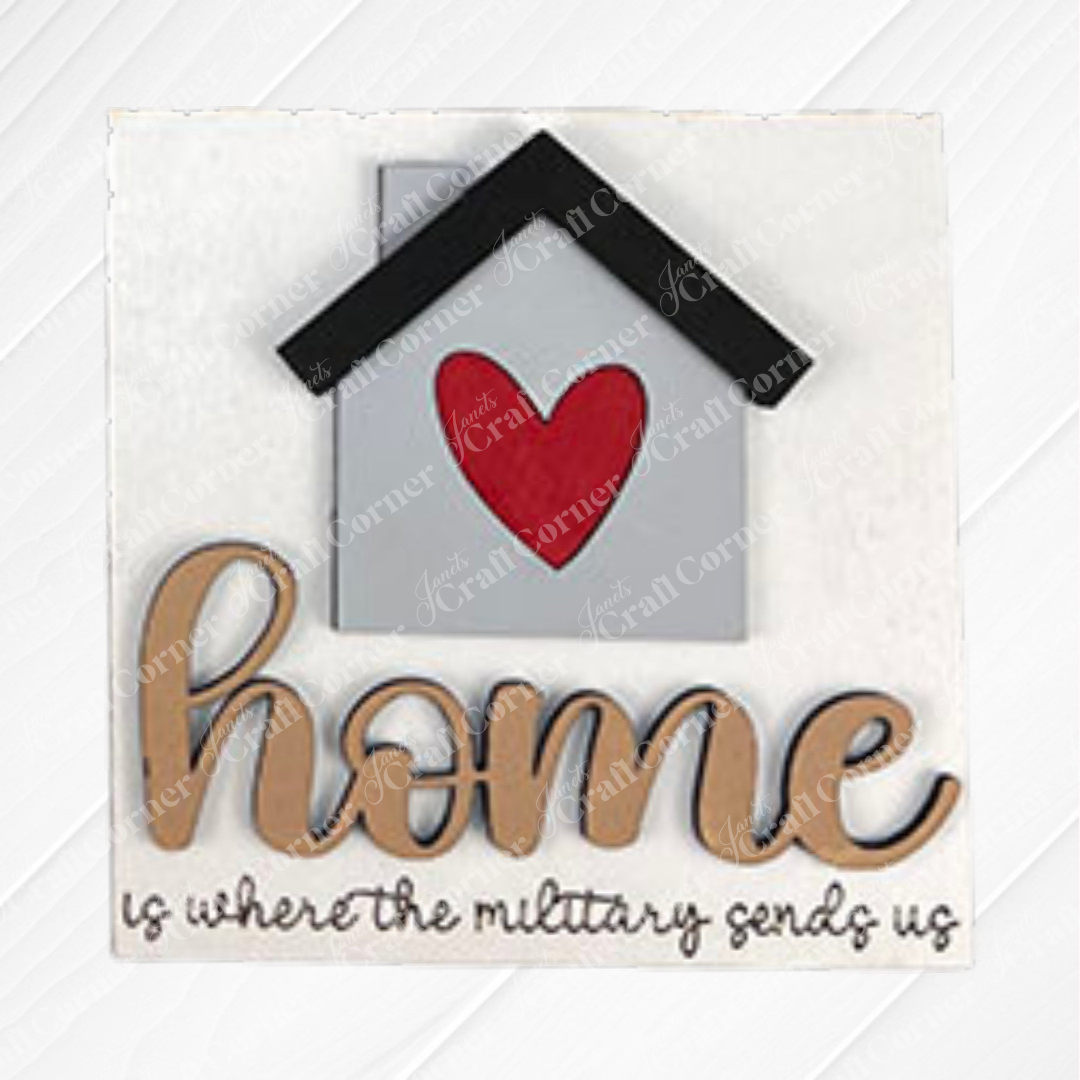 The Military Squares by Janet's Craft Corner feature a house with a red heart and black roof above the script "home is where the military sends us." Ideal as tiered tray decor or paired with Swappable Squares for seasonal updates.