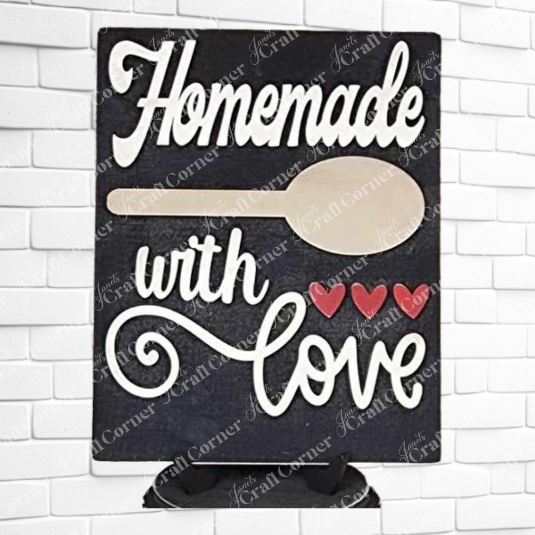 Janet's Craft Corner Kitchen Switchable Farmhouse Sign, a DIY home decor craft kit featuring "Homemade with love" in white script, wooden spoon, and red hearts, adds charming rustic flair to your kitchen. Set of 1.