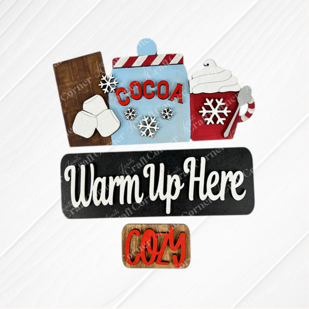 The Hot Cocoa Interchangeable Insert DIY home décor kit from Janet's Craft Corner is perfect for enhancing your home décor. It includes charming wooden cutouts depicting a cocoa jar with marshmallows and whipped cream, a chocolate bar, snowflakes, and the words "Warm Up Here" and "Cozy," making it ideal for any painted craft project.