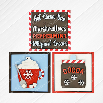 Janet's Craft Corner Hot Cocoa Squares: a three-piece tiered tray set with "Hot Cocoa Bar" sign, red mug with cocoa and whipped cream, and festive snowflake cocoa jar—perfect DIY seasonal home decor.